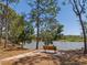 Bench by the lake under a grove of trees in the Herons Nest nature park at 12014 Beeflower Dr, Lakewood Ranch, FL 34202