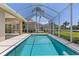 Backyard pool featuring a large screened enclosure with mature landscaping at 12014 Beeflower Dr, Lakewood Ranch, FL 34202
