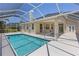 Backyard with screened pool, covered lanai, providing a private outdoor oasis with mature landscaping at 12014 Beeflower Dr, Lakewood Ranch, FL 34202