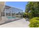 Screened pool featuring a concrete patio area with lush landscaping at 12014 Beeflower Dr, Lakewood Ranch, FL 34202