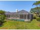 A screened-in pool offers a private and relaxing outdoor space in a beautifully landscaped backyard at 12014 Beeflower Dr, Lakewood Ranch, FL 34202