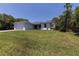 Exterior view of a one-story home with a grassy front yard at 12534 Mohican Ave, Port Charlotte, FL 33953