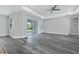 Spacious living room with hardwood floors, sliding glass doors, and a ceiling fan at 12534 Mohican Ave, Port Charlotte, FL 33953