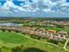Panoramic aerial view of a large golf community featuring lakes, lush fairways, and beautiful tiled roof homes at 12720 Sorrento Way # 103, Bradenton, FL 34211