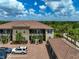 Aerial view of a beautiful condo building showcasing tiled roofs and lush landscaping with a golf course view at 12720 Sorrento Way # 103, Bradenton, FL 34211
