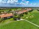 Beautiful aerial view of a golf course community featuring lakes, lush fairways, and tiled roof homes at 12720 Sorrento Way # 103, Bradenton, FL 34211