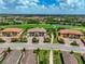 Aerial view of community featuring lush landscaping, golf course, and multiple residential buildings at 12720 Sorrento Way # 103, Bradenton, FL 34211