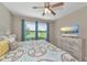 Bright bedroom with ceiling fan and golf course view from the window at 12720 Sorrento Way # 103, Bradenton, FL 34211