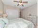 Comfortable bedroom featuring a bed, ceiling fan, chest of drawers, and ample closet space at 12720 Sorrento Way # 103, Bradenton, FL 34211