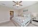 Spacious bedroom with ceiling fan, neutral walls, and carpeted floor at 12720 Sorrento Way # 103, Bradenton, FL 34211