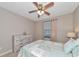 Bright bedroom with beach-themed decor, a ceiling fan, and a window providing natural light at 12720 Sorrento Way # 103, Bradenton, FL 34211