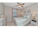 Well-lit bedroom featuring a ceiling fan and coastal-themed decorations for a beach-inspired aesthetic at 12720 Sorrento Way # 103, Bradenton, FL 34211