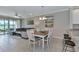 Inviting dining area featuring a stylish table with seating for six, seamlessly flowing into the living room with a golf course view at 12720 Sorrento Way # 103, Bradenton, FL 34211