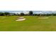 Scenic golf course featuring lush green grass, sand traps, and mature trees at 12720 Sorrento Way # 103, Bradenton, FL 34211