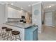Well-lit kitchen with white cabinets, granite countertops, a breakfast bar with seating, and stainless steel appliances at 12720 Sorrento Way # 103, Bradenton, FL 34211
