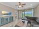 Beautifully staged living room with tile floors, golf course view, a gray sofa and a stylish accent chair at 12720 Sorrento Way # 103, Bradenton, FL 34211