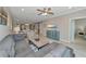 Spacious living room showcasing the open floor plan with a view of the dining area and an adjacent bedroom at 12720 Sorrento Way # 103, Bradenton, FL 34211
