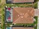 Aerial view of house with red tiled roof, screened pool, lush landscaping and patio seating at 13786 Vancanza Dr, Venice, FL 34293