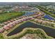 A stunning aerial view of a lakeside community highlighting the neighborhood's layout and landscaping at 13786 Vancanza Dr, Venice, FL 34293