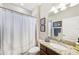 Bathroom featuring a single sink vanity with granite countertop, a shower with curtain, and tiled floors at 13786 Vancanza Dr, Venice, FL 34293