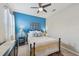 Cozy bedroom features a striking accent wall, a comfortable bed, and soft, natural lighting at 13786 Vancanza Dr, Venice, FL 34293