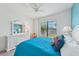 Comfortable bedroom with bright window views, a blue accent wall, and cozy furniture at 13786 Vancanza Dr, Venice, FL 34293
