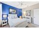 Bright bedroom featuring a blue accent wall, white furniture, and serene decor at 13786 Vancanza Dr, Venice, FL 34293
