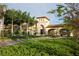 Beautiful view of the community's entrance featuring manicured gardens and an inviting gateway at 13786 Vancanza Dr, Venice, FL 34293