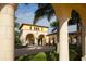 Charming view through the columns of the impressive community entrance and landscaping at 13786 Vancanza Dr, Venice, FL 34293