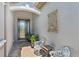 Inviting entryway featuring a decorative front door, stylish seating, and custom wall art at 13786 Vancanza Dr, Venice, FL 34293