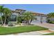 Beautiful home exterior with a red tile roof, paver driveway and well-manicured landscaping at 13786 Vancanza Dr, Venice, FL 34293