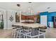 Spacious kitchen with a large center island, pendant lighting, and counter seating at 13786 Vancanza Dr, Venice, FL 34293