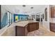 Kitchen island with marble countertop, sink, and bar seating perfect for entertaining at 13786 Vancanza Dr, Venice, FL 34293