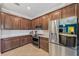 A well-appointed kitchen features stainless steel appliances, granite countertops, and ample cabinet space at 13786 Vancanza Dr, Venice, FL 34293