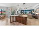 Open-concept kitchen and living room area with stainless appliances and access to outdoor patio at 13786 Vancanza Dr, Venice, FL 34293