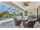 The backyard patio offers a beautiful view of the pool and picturesque lake at 13786 Vancanza Dr, Venice, FL 34293
