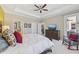 Bright and airy main bedroom with ensuite bathroom, walk-in closets, and comfortable seating area at 13786 Vancanza Dr, Venice, FL 34293