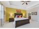 Comfortable main bedroom featuring a tray ceiling, ensuite bathroom, and neutral decor at 13786 Vancanza Dr, Venice, FL 34293