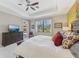 Spacious bedroom with a large dresser and access to the lanai through sliding glass doors at 13786 Vancanza Dr, Venice, FL 34293