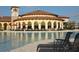 Relaxing poolside view featuring comfortable lounge chairs, elegant umbrellas, and picturesque surroundings at 13786 Vancanza Dr, Venice, FL 34293