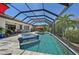 Relaxing screened-in pool with a spa, complemented by beautiful landscaping and comfortable patio seating at 13786 Vancanza Dr, Venice, FL 34293