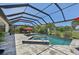 Screened-in pool and spa area with outdoor seating, set against a lush landscape at 13786 Vancanza Dr, Venice, FL 34293