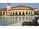An inviting community pool surrounded by elegant architecture, lounge chairs, and landscaped areas at 13786 Vancanza Dr, Venice, FL 34293