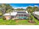 An aerial view of screened-in pool, solar panels, landscaping, and lawn at 1447 Gleneagles Dr, Venice, FL 34292