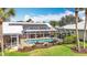 Aerial view of screened pool and solar panels on roof, complemented by landscaping and lawn at 1447 Gleneagles Dr, Venice, FL 34292