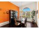 Elegant dining room features a glass table, hardwood floors, and a large arched window at 1447 Gleneagles Dr, Venice, FL 34292