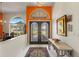 Grand foyer with a decorative rug, high ceilings, an arched window, and a stunning view at 1447 Gleneagles Dr, Venice, FL 34292