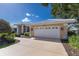 This charming home features a large attached garage and meticulously maintained landscaping at 1447 Gleneagles Dr, Venice, FL 34292
