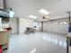 Spacious garage features epoxy floors, built-in storage, and ample room for parking and projects at 1447 Gleneagles Dr, Venice, FL 34292