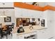 Open kitchen with breakfast bar looking into the living room and dining area at 1447 Gleneagles Dr, Venice, FL 34292